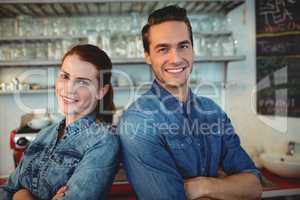 Portrait of happy baristas at coffee house