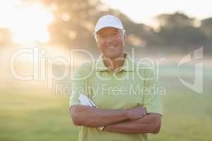 Portrait of smiling golfer with arms crossed