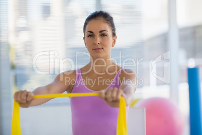 Portrait of woman holding resistance band