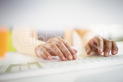 Close-up of of businesswoman typing on keyboard