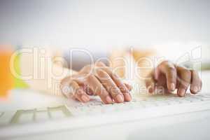 Close-up of of businesswoman typing on keyboard