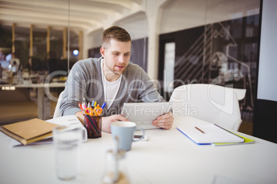 Businessman working using digital tablet in creative office