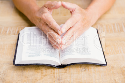 Person with bible at table