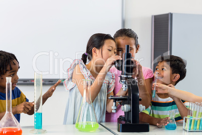 Children looking in microscope