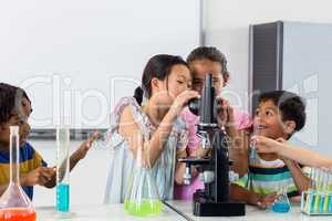 Children looking in microscope