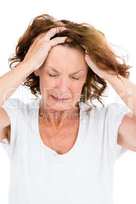 Irritated mature woman with head in hands