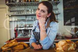 Portrait of attractive barista at counter in cafe