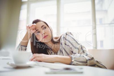 Tired businesswoman relaxing in creative office