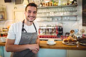 Portrait of happy barista at coffee house