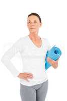 Mature woman holding exercise mat