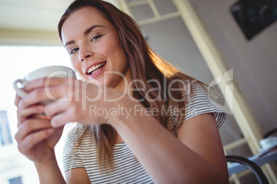 Portrait of happy woman with coffee at cafe
