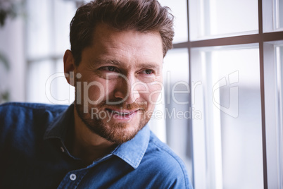 Close-up of happy executive by window at office