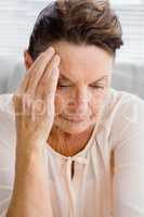 Upset woman suffering from headache