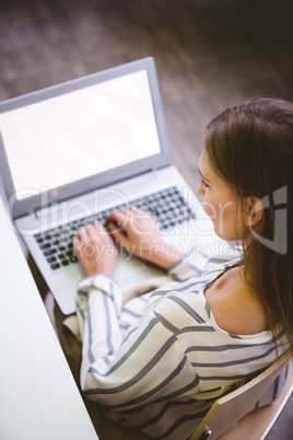 High angle view of female executive with laptop at office