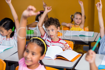 Thoughtful boy raising his hand