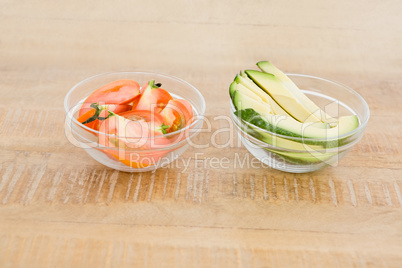 Tomato and avocado slices in bowl