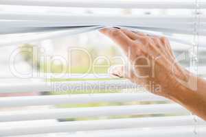 Person hand on blinds
