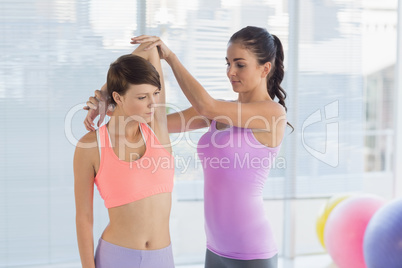 Trainer assisting pretty woman Trainer assisting pretty woman