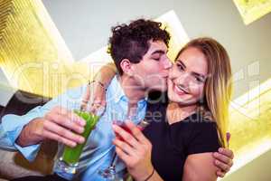 Man kissing woman in nightclub
