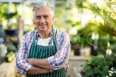 Confident male gardener against greenhouse