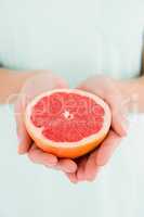 Woman holding grapefruit