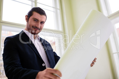 Portrait of architect holding blueprint