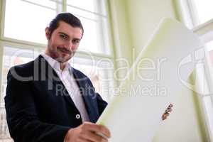 Portrait of architect holding blueprint