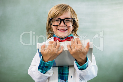 Portrait of boy dressed as scientist in classroom