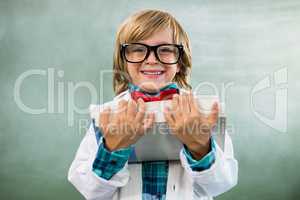 Portrait of boy dressed as scientist in classroom