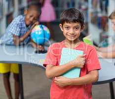 Happy holding books against classmates