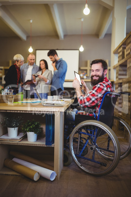 Smiling disabled businessman using digital tablet