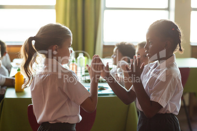 Girls playing clapping game