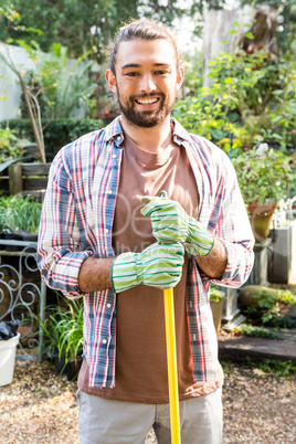 Portrait of hipster gardener with tool at garden