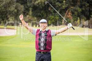 Golfer raising his arms