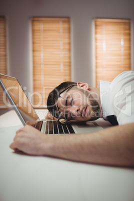 Young man sleeping in office