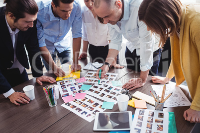 High angle view of of photo editors looking at photos