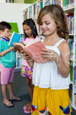 Students reading books in school library