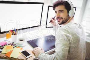 Portrait of businessman using graphics tablet in office