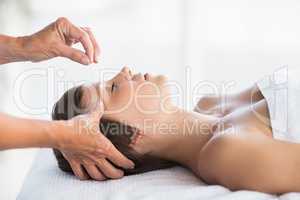 Woman receiving acupuncture treatment