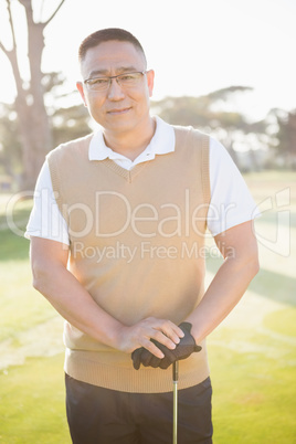 Portrait of golfer posing with his golf club