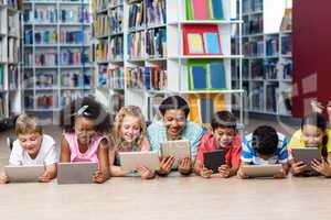 Teacher with students using digital tablet