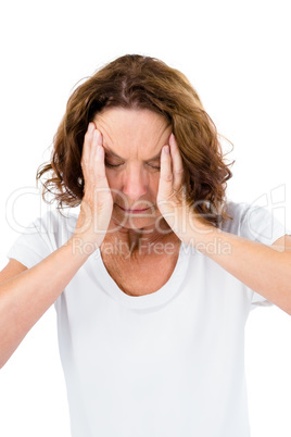 Unhappy mature woman with head in hands