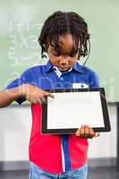 Boy using digital tablet in classroom