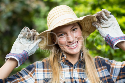 Happy female gardener wearing hat