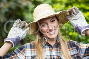 Happy female gardener wearing hat