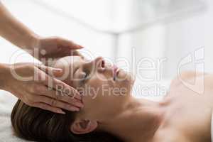 Massuer treating customer in spa