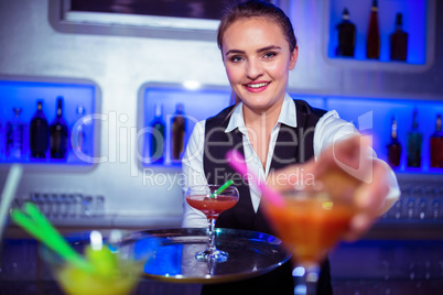 Portrait of bartender serving cocktail