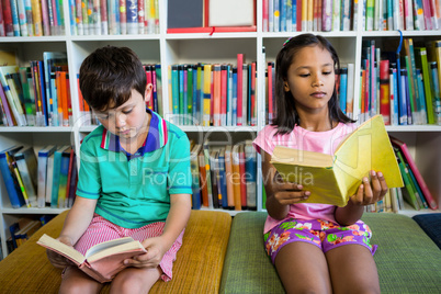 Students reading books in school library