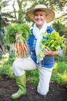 Portrait of happy customer holding fresh vegetables at garden