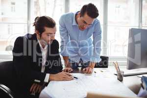 Interior designer with male colleague working in office